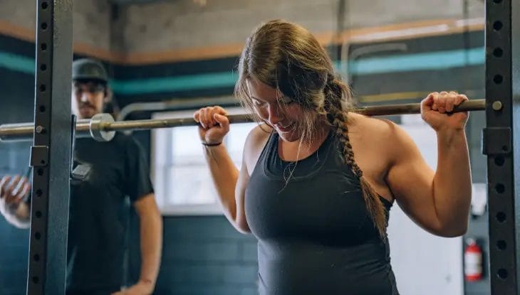 Women lifting barbell pole